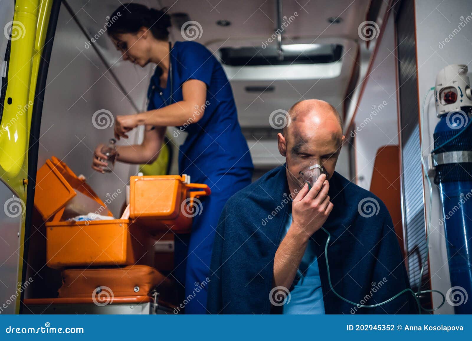 A Medical Worker Preparing a Dropping Tube, a Man with an Oxygen Mask