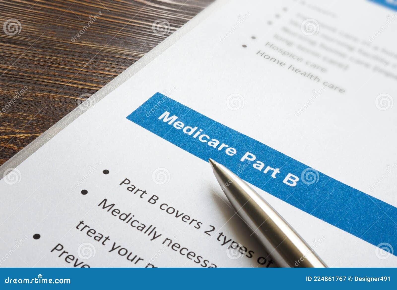 medicare part b cover list and metal pen.