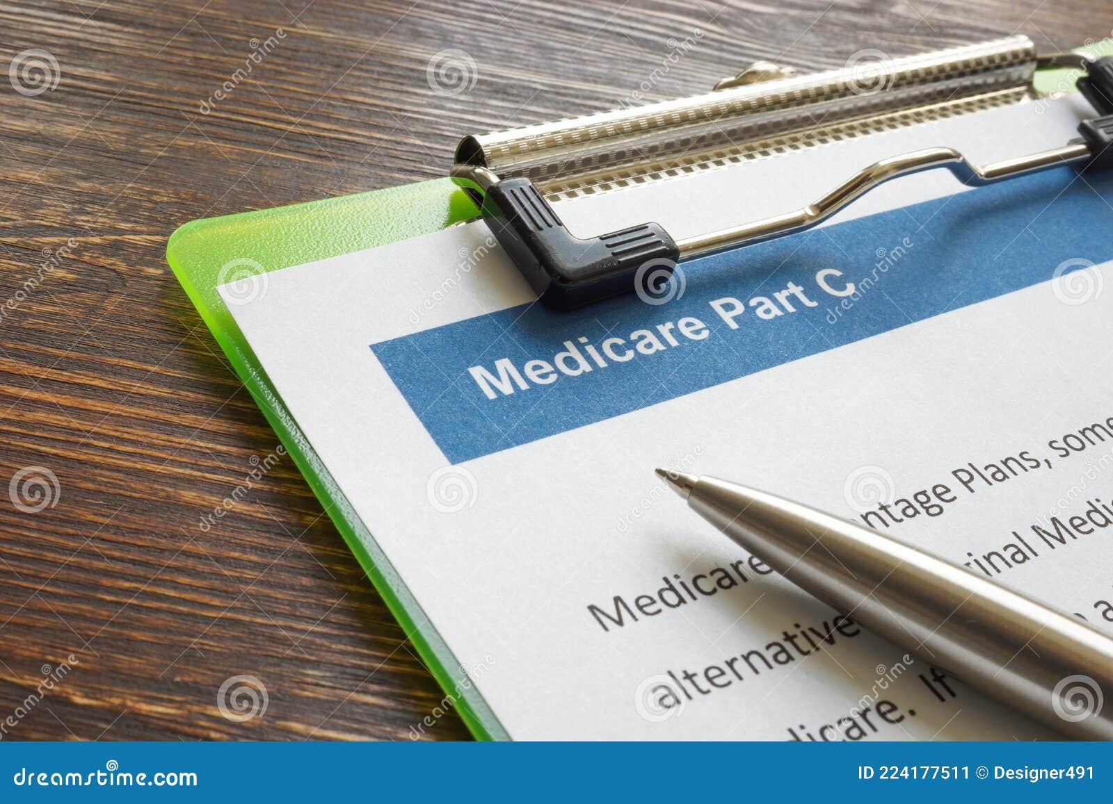 medicare part c insurance papers with clipboard and pen.