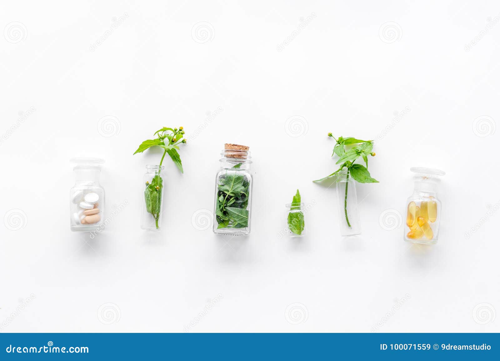 medicinal herb in bottles on white background top view copyspace