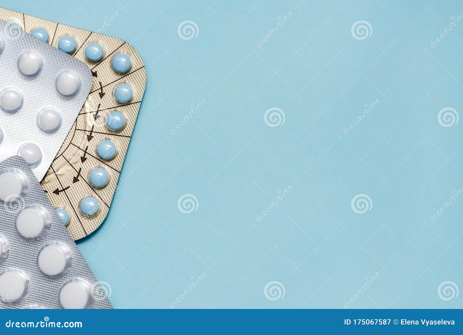 medicine pills on on blue backdrop. copy space