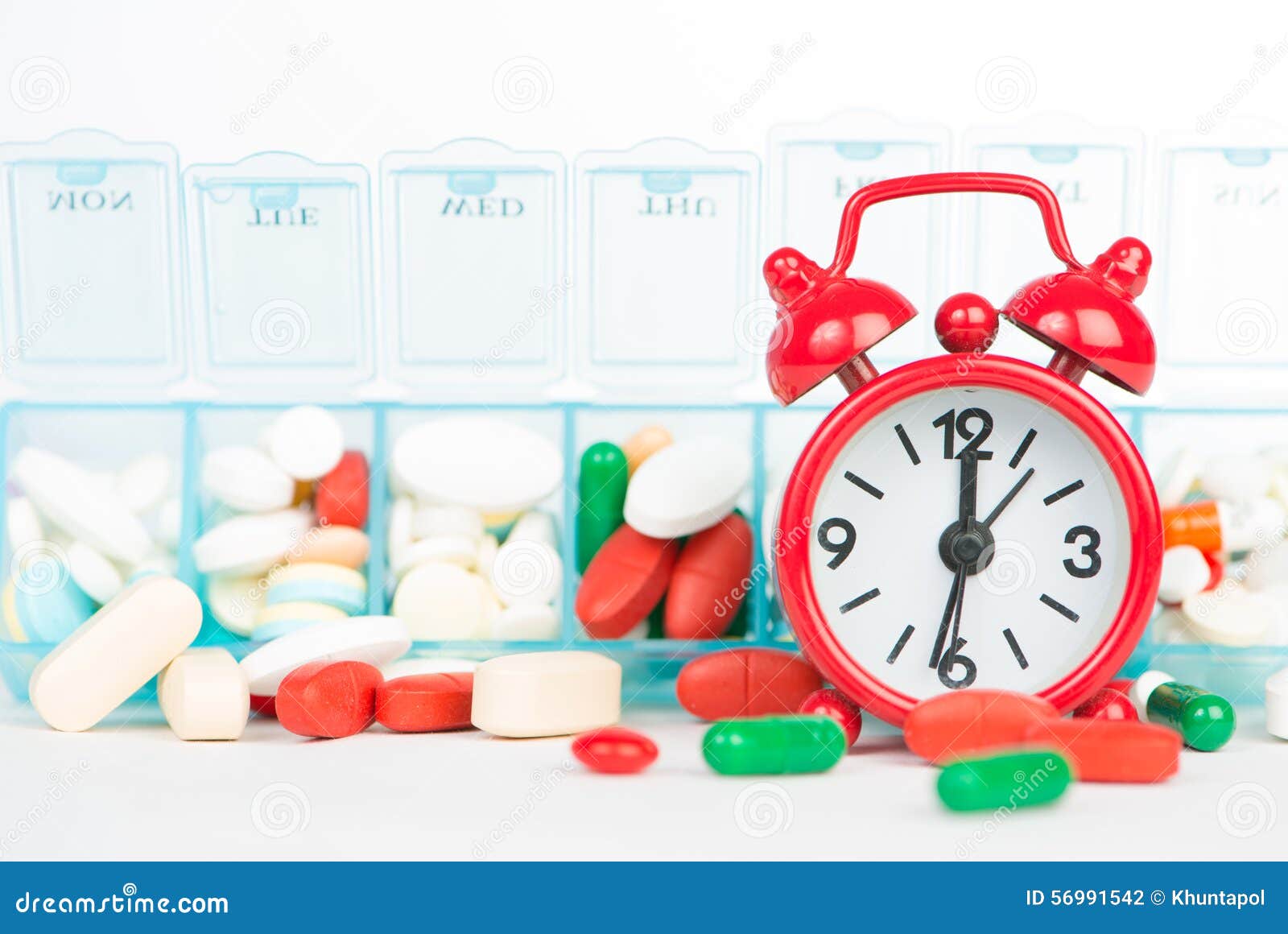 Medicine In Weekly Pill Box And Red Alarm Clock Stock Photo Image of