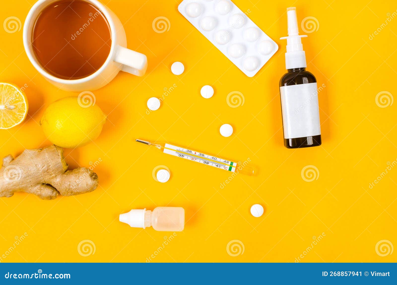 Lemon, ginger, tea, thermometer and white medical pills, traditional and folk methods of treatment. Medicines for treatment- pills, spray bottles, thermometer, Lemon, ginger and tea. traditional and folk methods of treatment. Pharmaceuticals and medicine. Illness concept