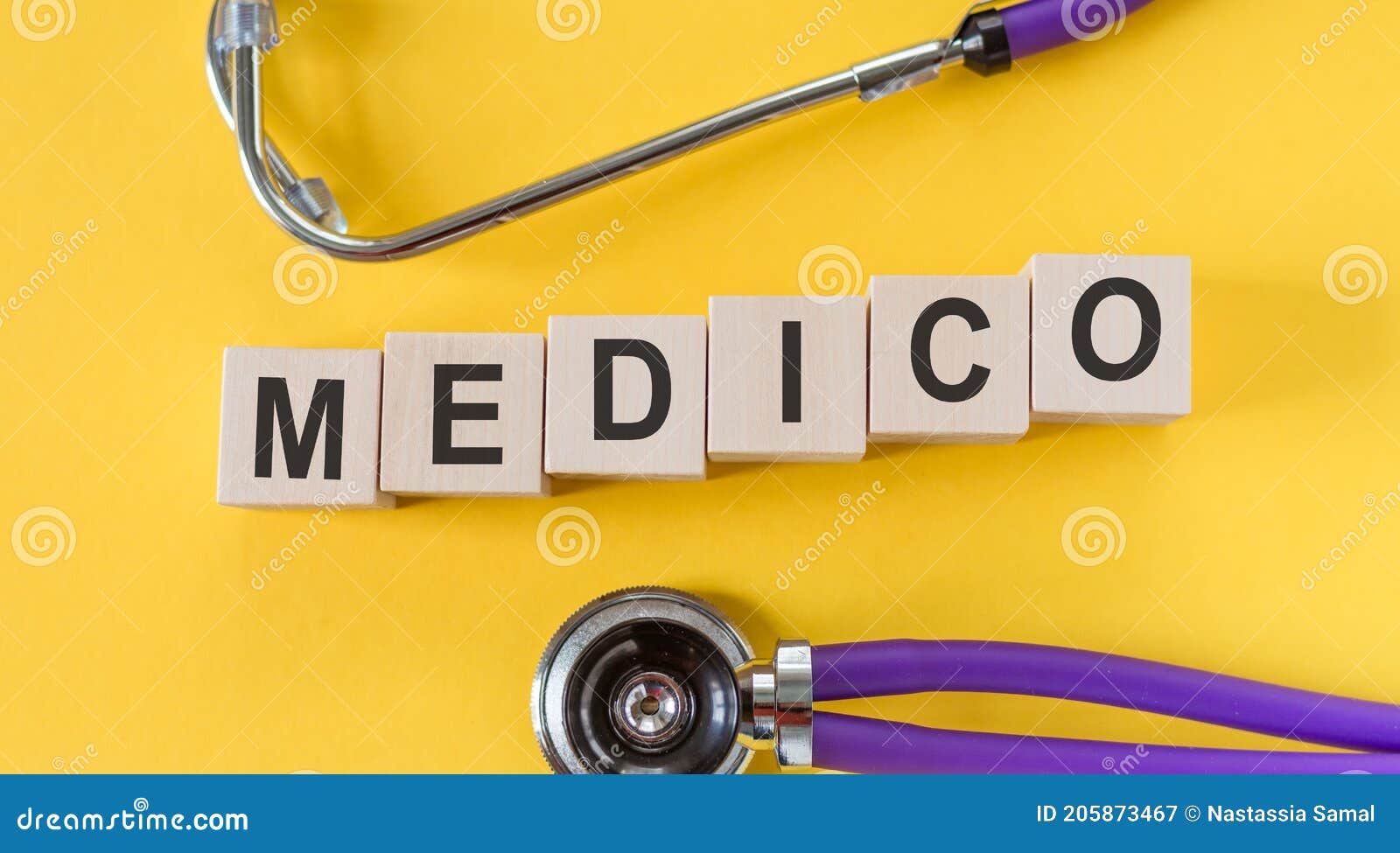 medico text made in building wood blocks on yellow desk
