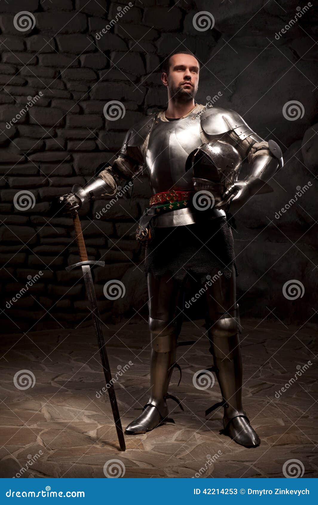 Medieval Knight Posing With Sword In A Dark Stone Stock Image - Image