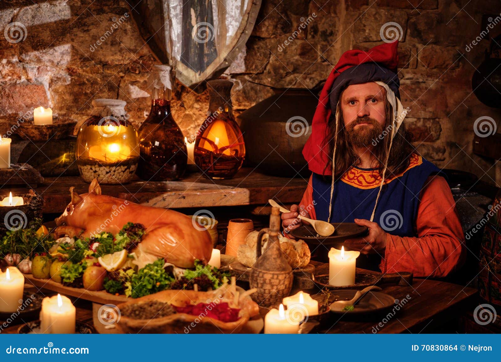 Medieval Man Eat and Drink in Ancient Castle Kitchen Interior. Stock