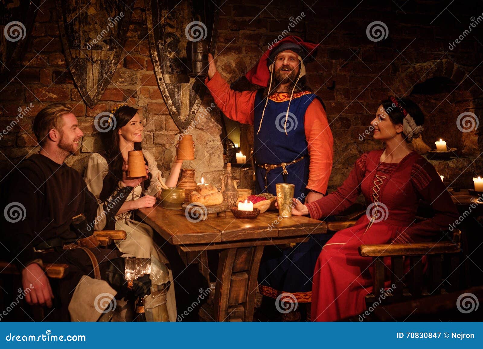 Medieval People Eat and Drink in Ancient Castle Tavern. Stock Image