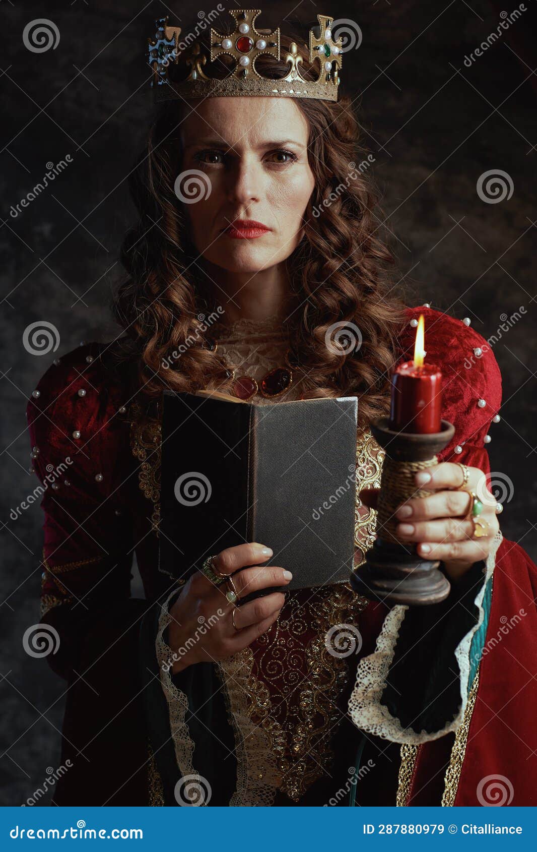 Medieval Queen in Red Dress with Book, Candle and Crown Stock Image ...