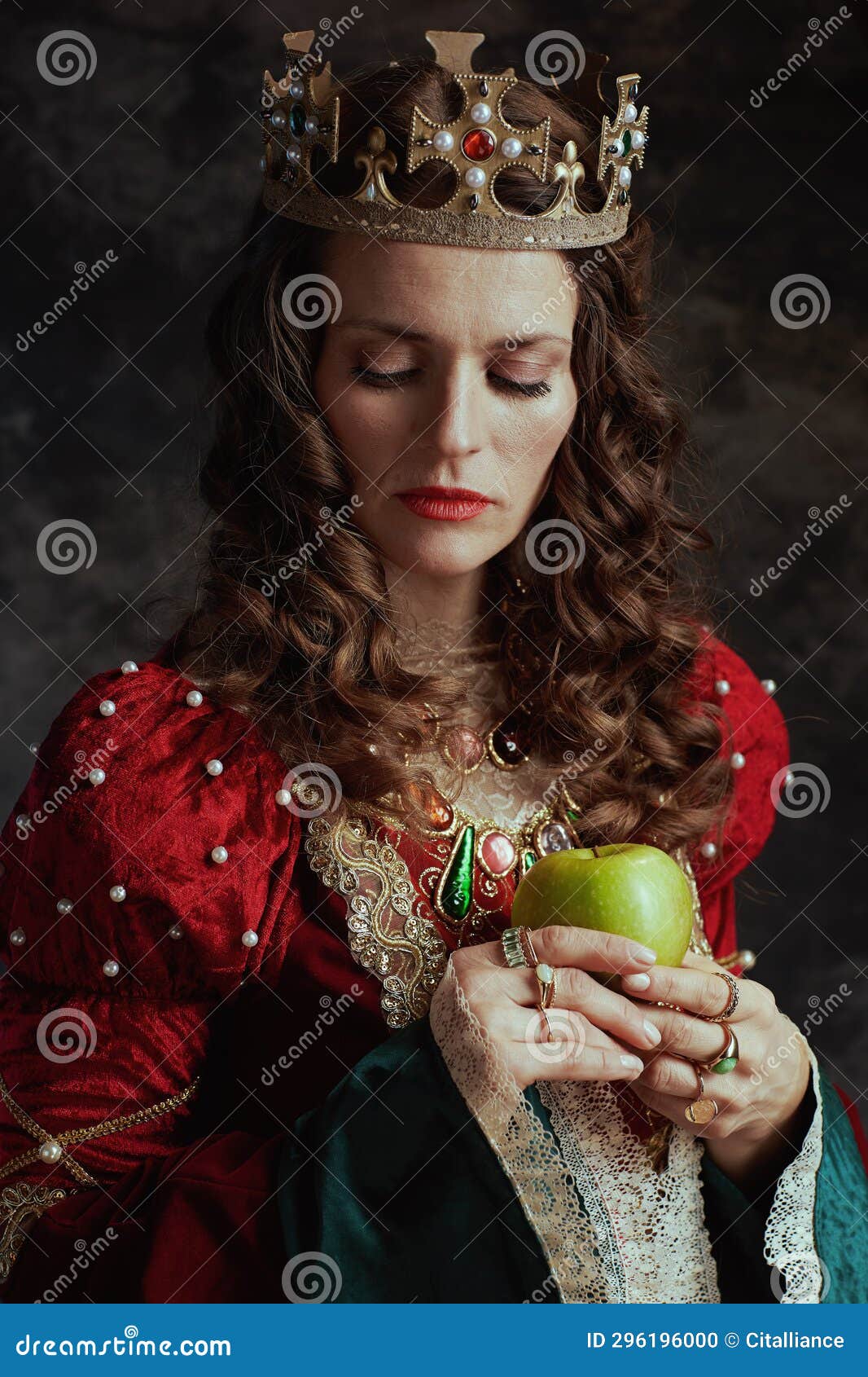 Medieval Queen in Red Dress with Green Apple and Crown Stock Photo ...