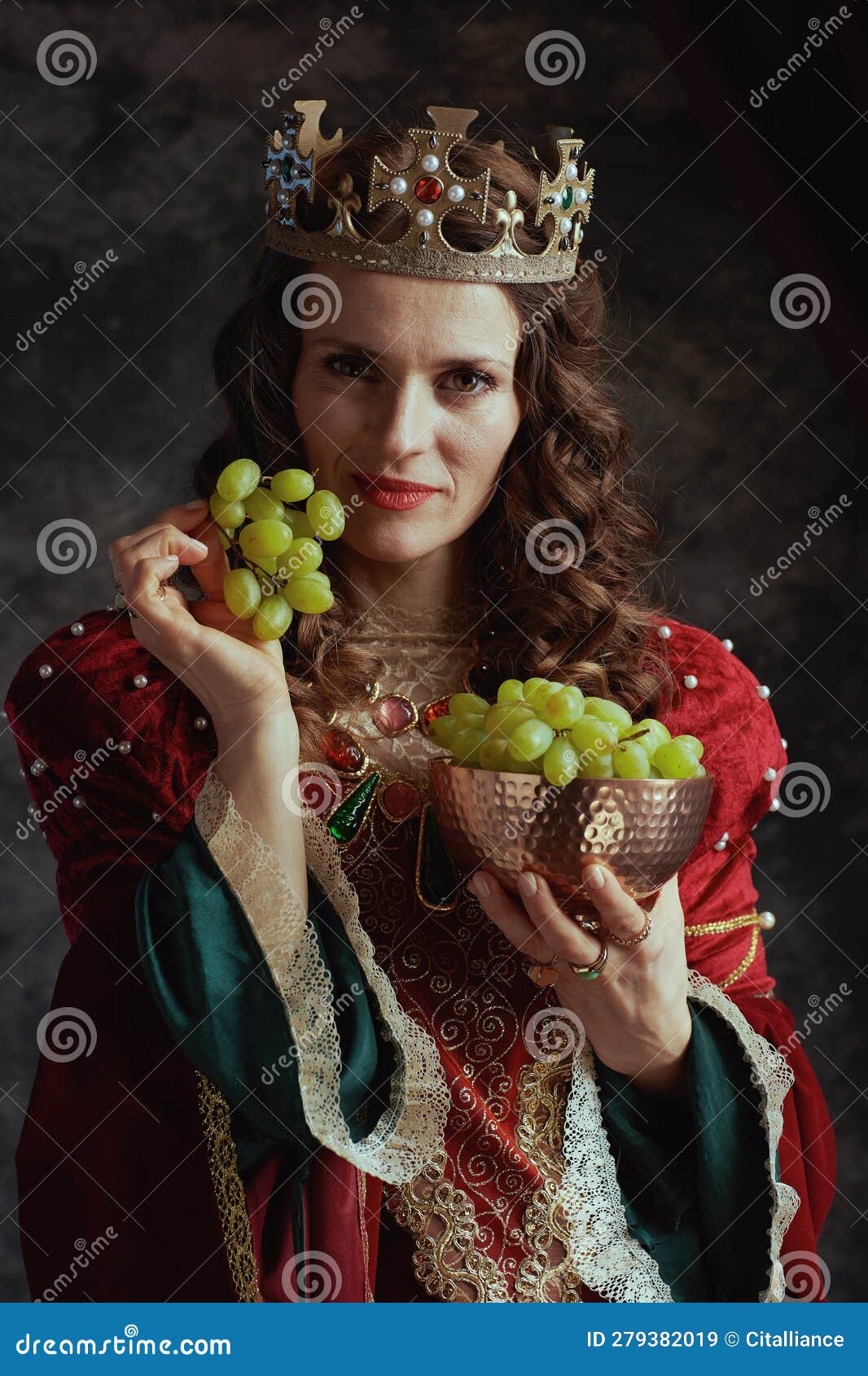 Medieval Queen in Red Dress with Plate of Grapes and Crown Stock Image ...