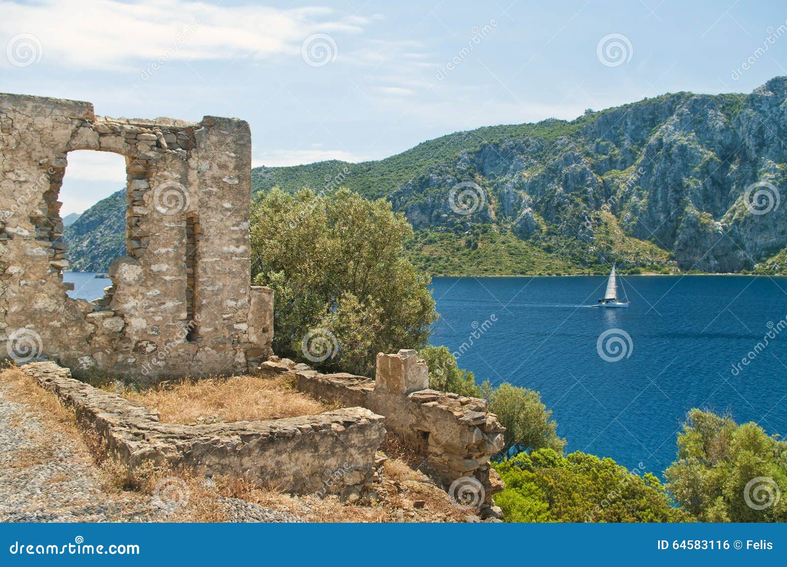 medieval ruins with sea and mountains at background