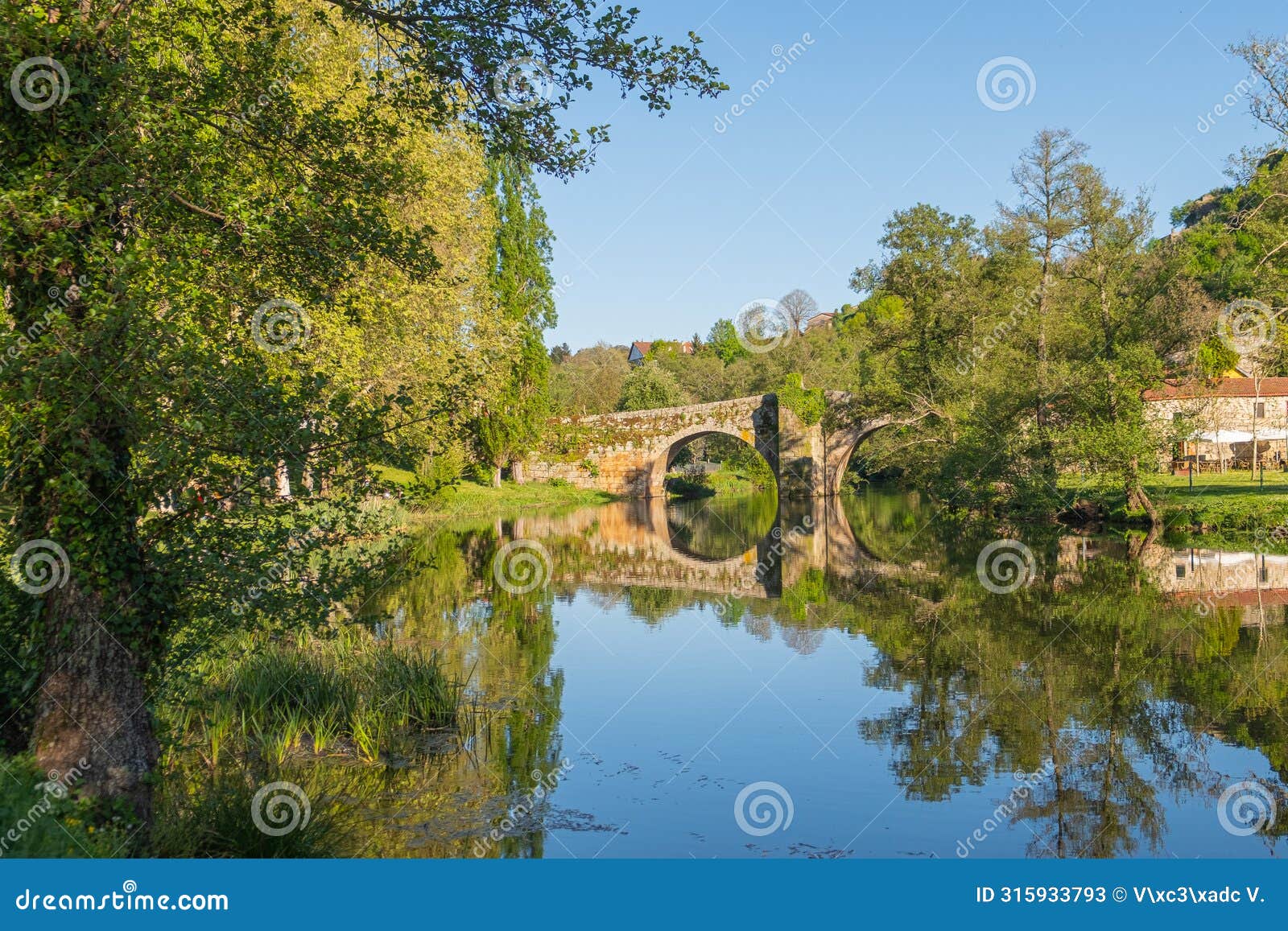 medieval stone bridge over the arnoia river in the beautiful village of allariz, galicia. spain