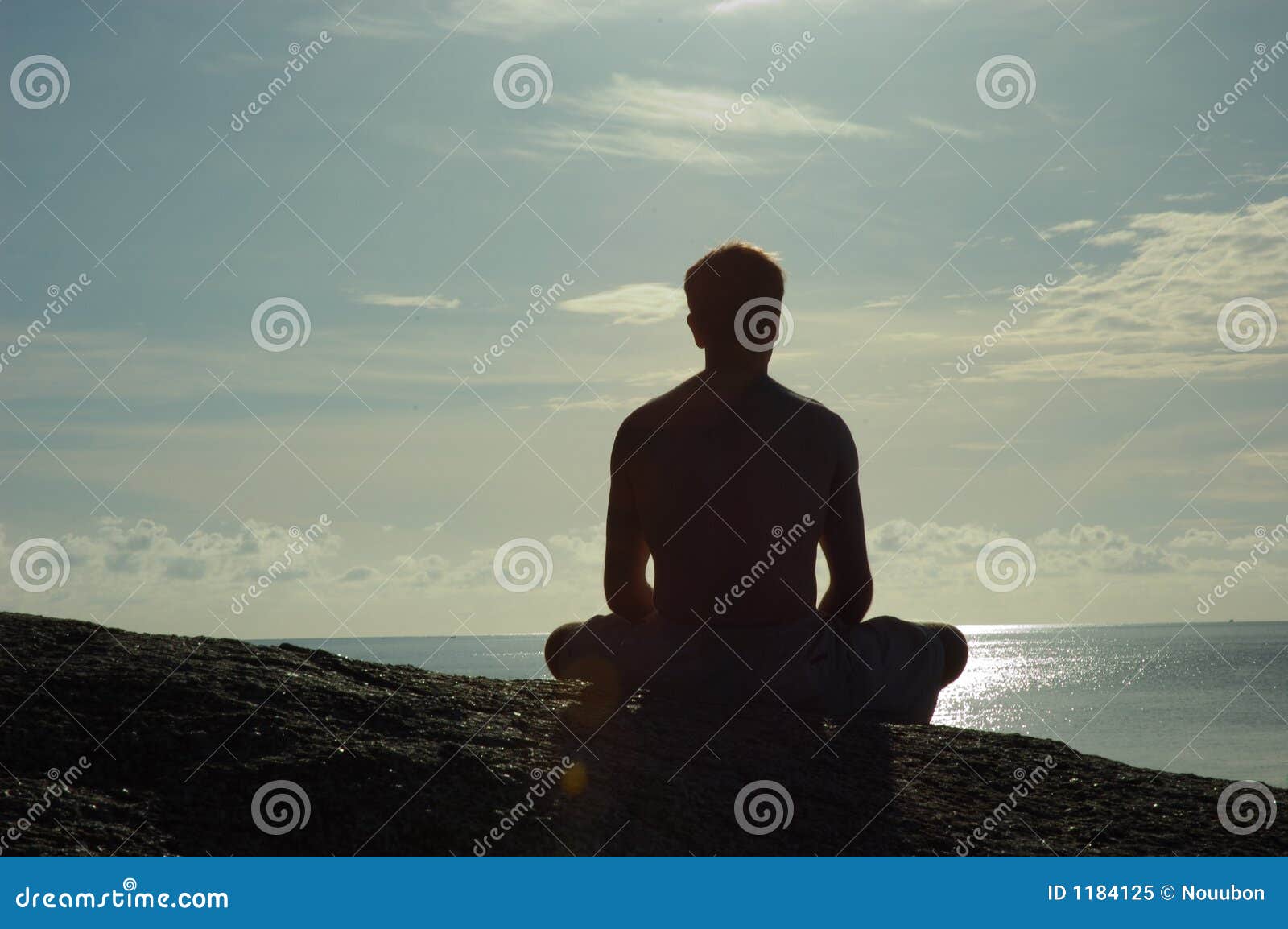 meditating at sunrise overlooking ocean