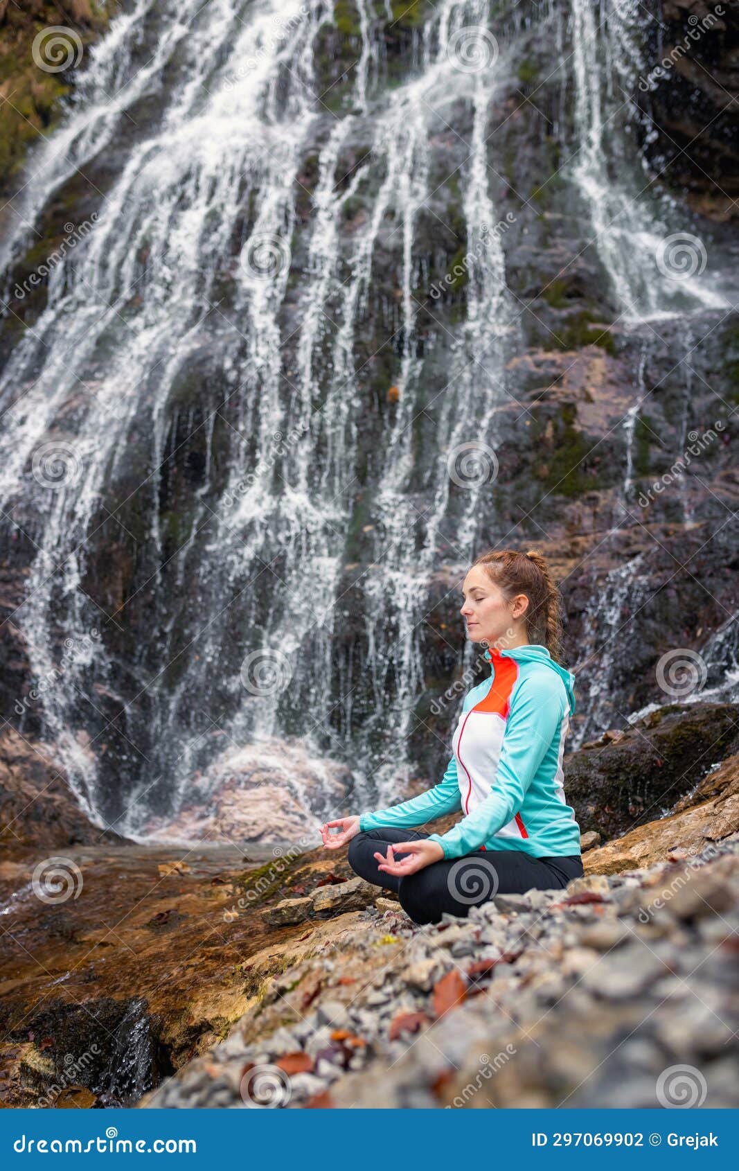 Meditation in Nature, a Girl Relaxing in a Yoga Pose Near a Waterfall ...