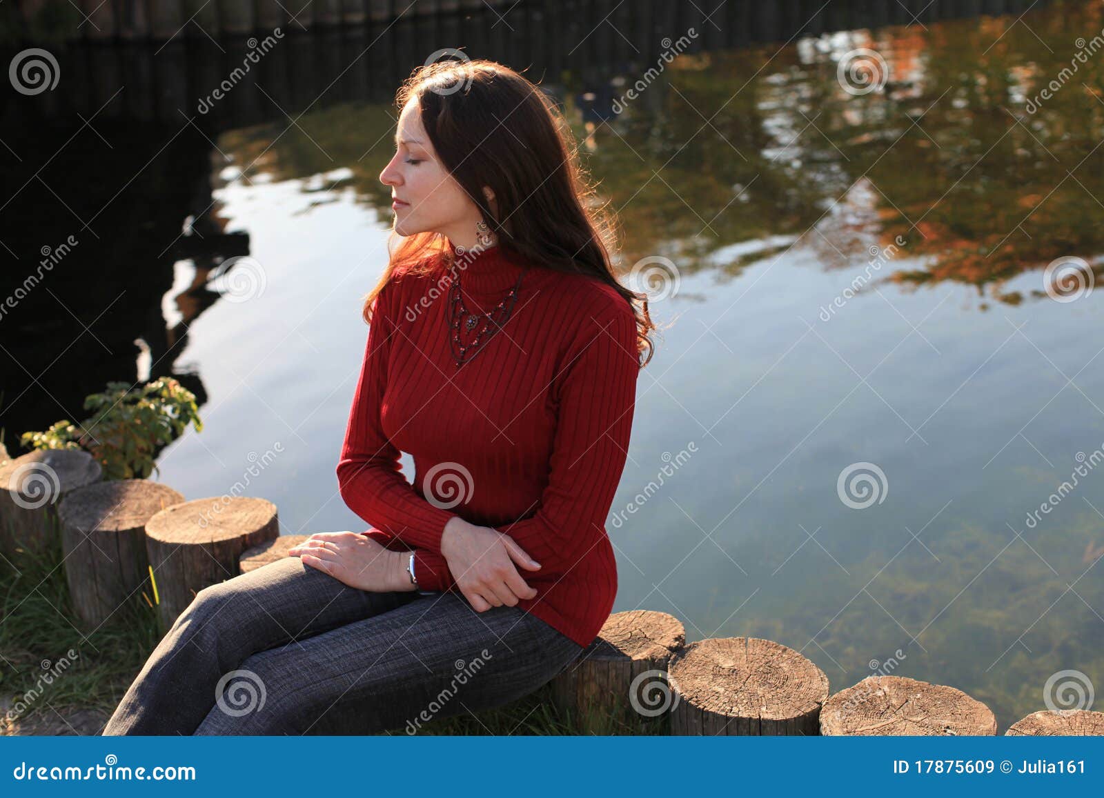 meditative woman by lake