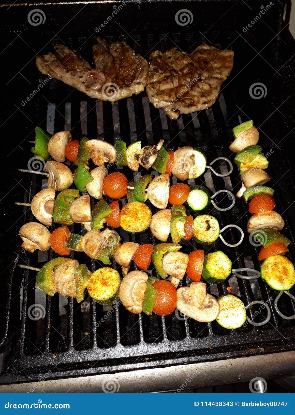 mediterranean lamb chops and vegetable skewers grilled over a smokey open coal fire