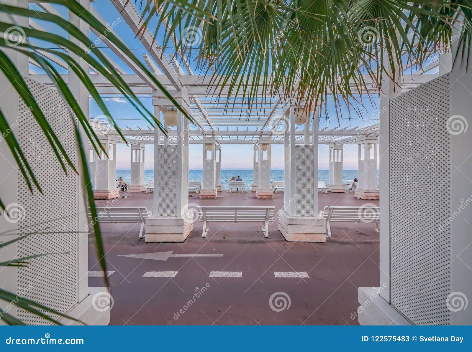 mediterranean sea and white colonnade on promenade des anglais at sunset in nice france