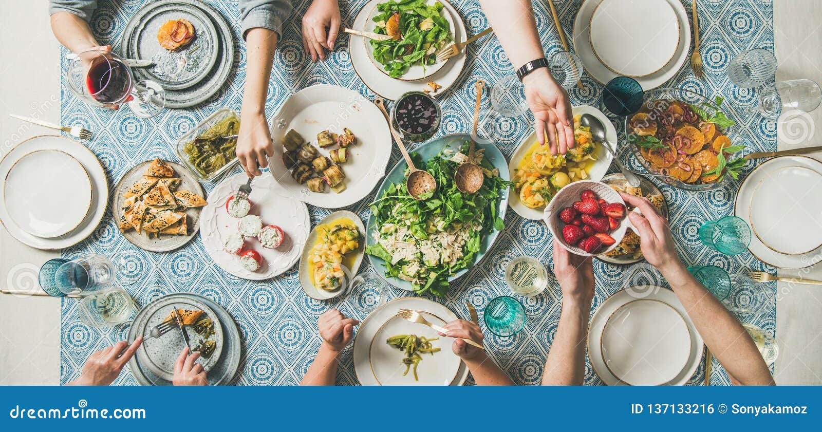 mediterranean style dinner with various snacks and drinks, wide composition