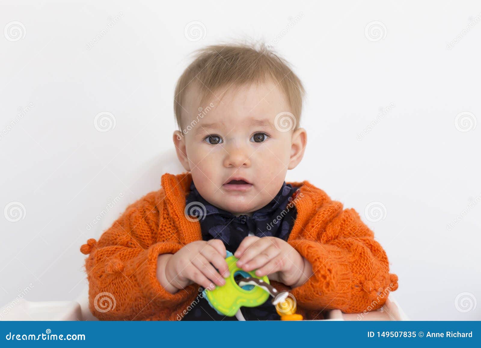 Medium Horizontal Shot Of Adorable Fair Toddler Girl Sitting