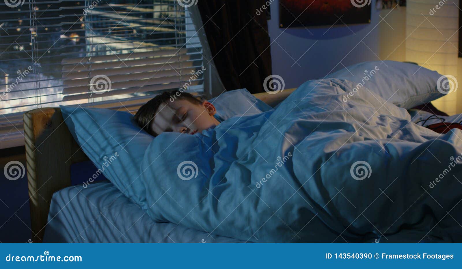 Boy sleeping in his bed stock photo. Image of night 143540390