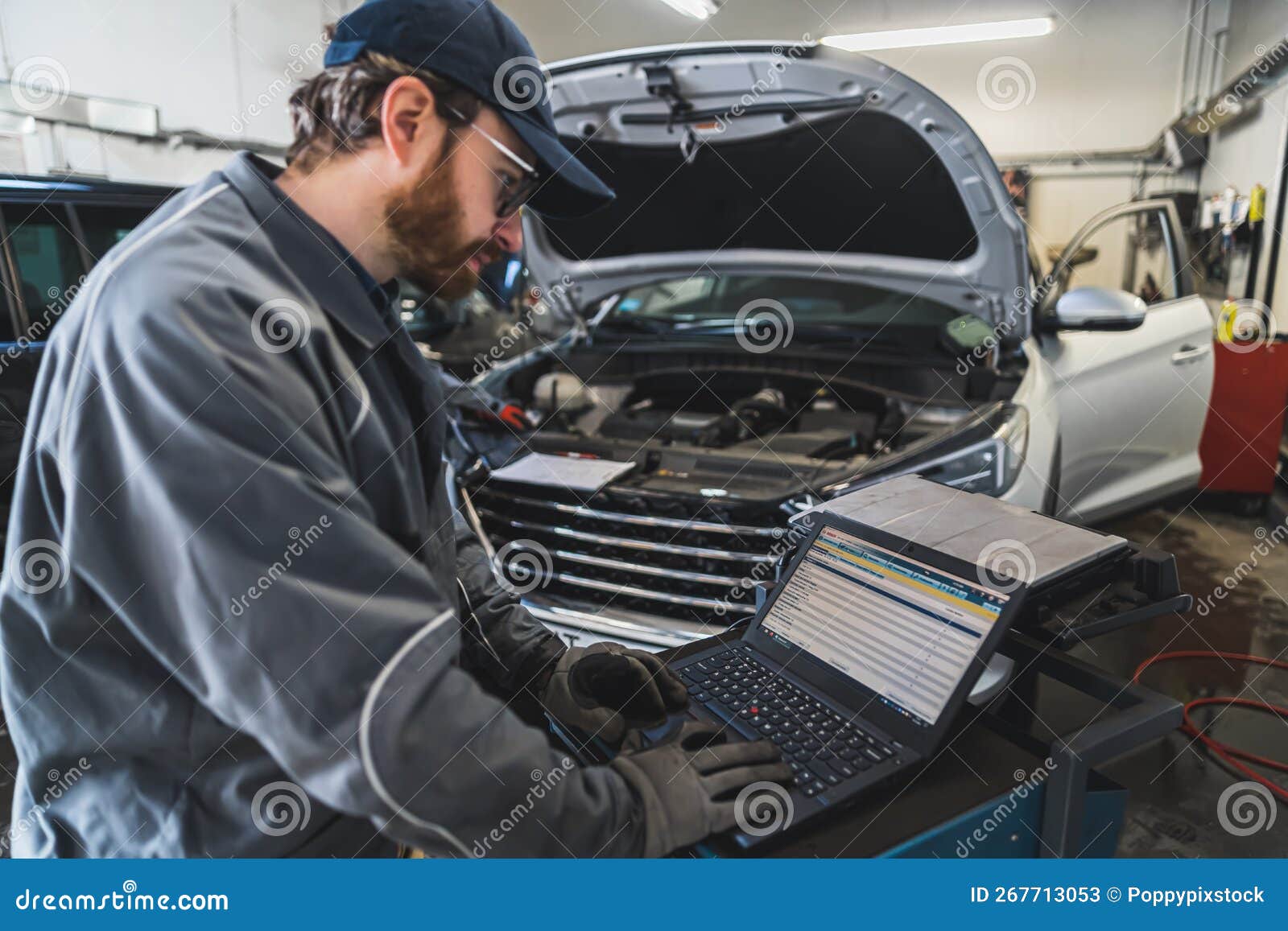Medium Shot of a Mechanic Doing Car Computer Diagnostics. Repair Shop