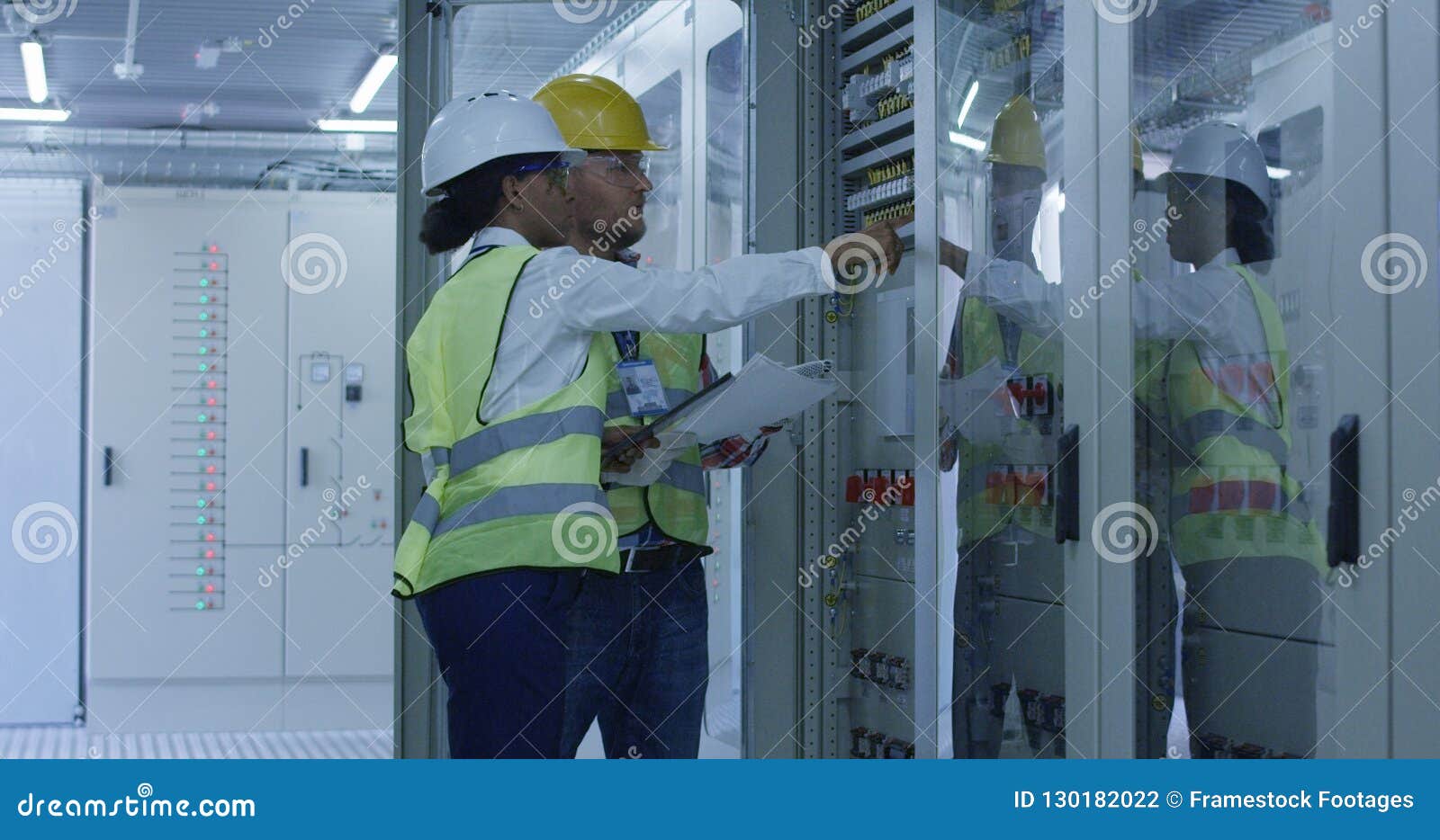 Two Electrical Workers Walking in the Control Room Stock Photo Image