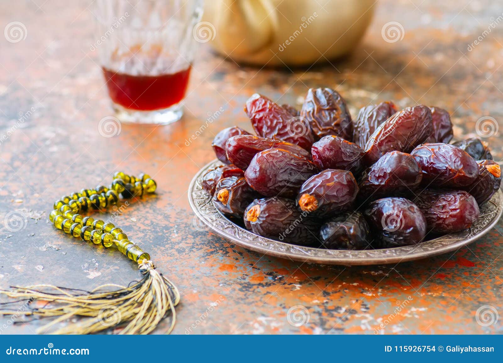 medjoul - dried dates or kurma in a vintage plate and tea.