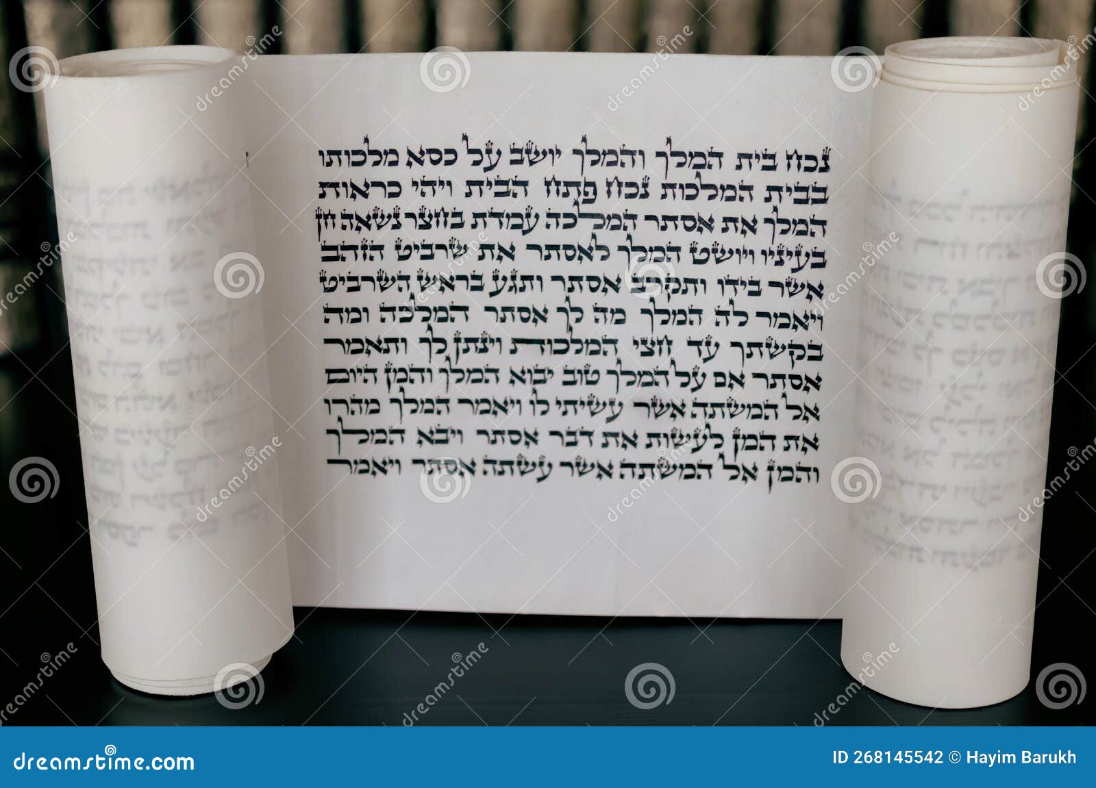 megillat esther (book of esther)  scroll on black backround and talmud.