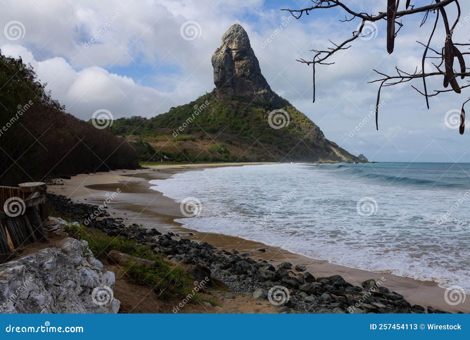 meio beach in brazil with a rocky shore on a bright sunny day