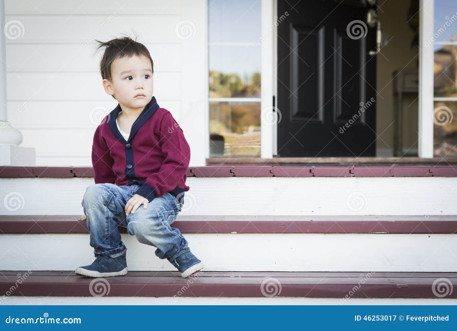 Melancholy Mixed Race Boy Sitting on Front Porch Steps Stock Image ...