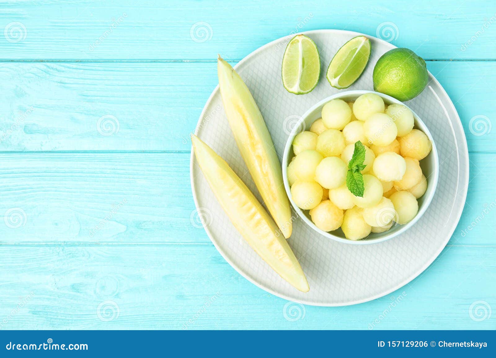 Melon Balls with Mint and on Light Blue Wooden Table, Top View. Space