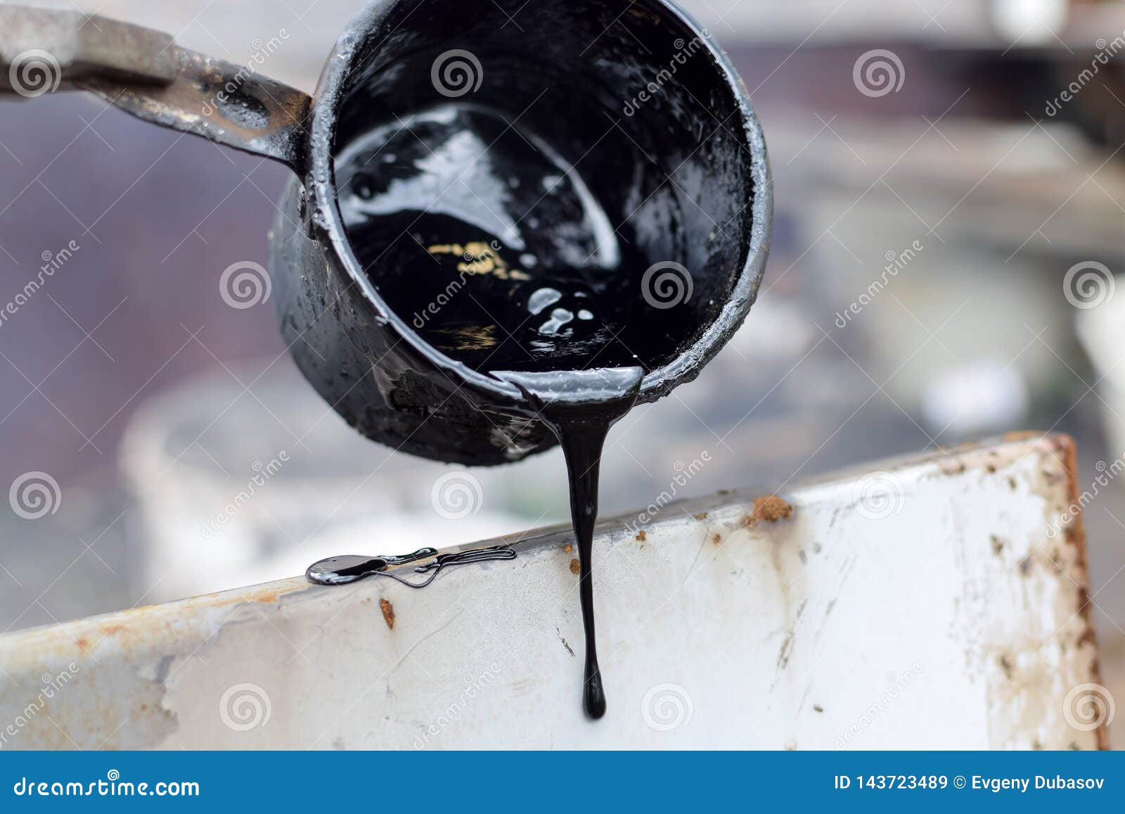 Melted Hot Black Tar from Metal Cup on Surface with Steam Stock Image