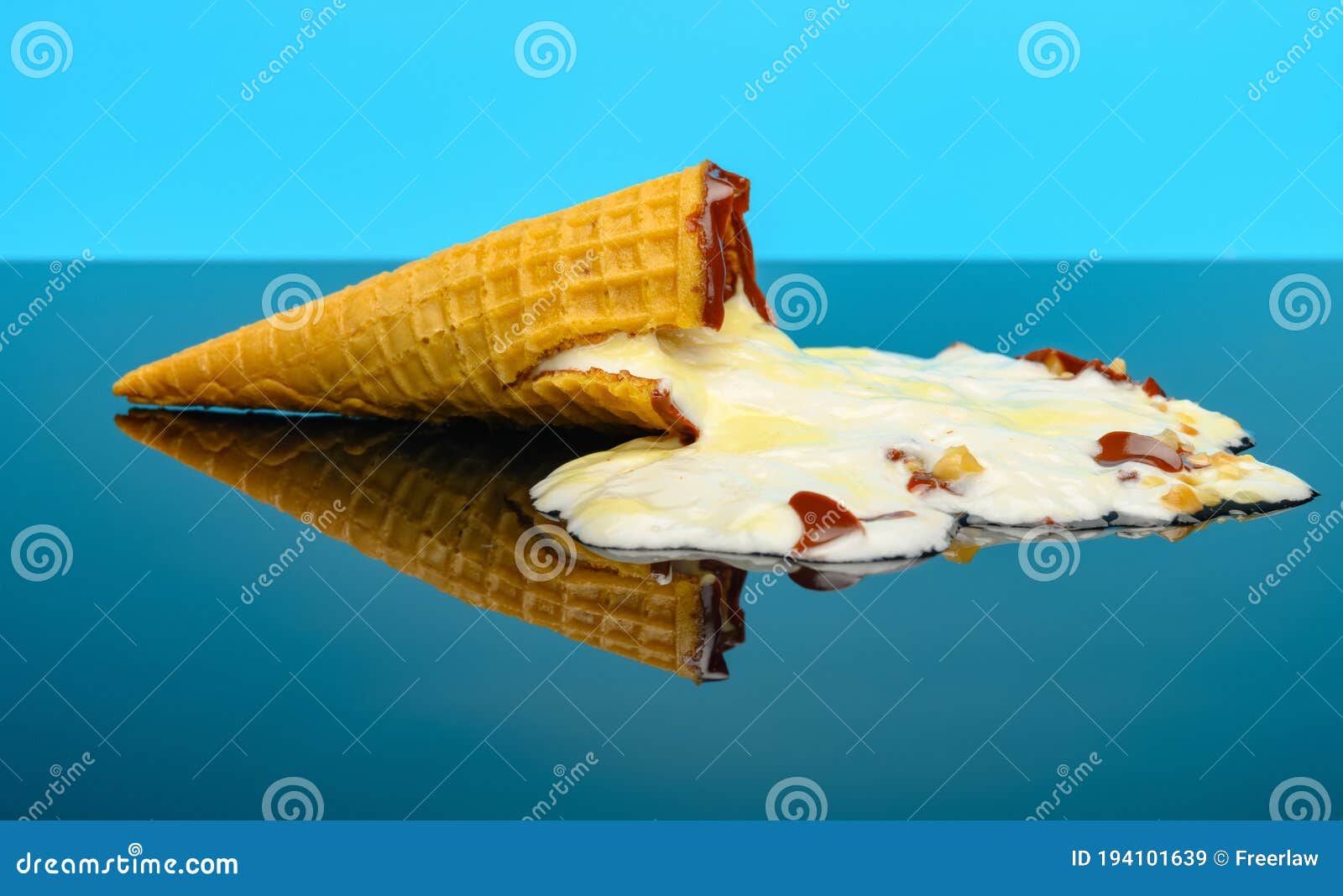 A Melted Vanilla Flavor Ice Cream Cone on a Glass with Reflection Stock