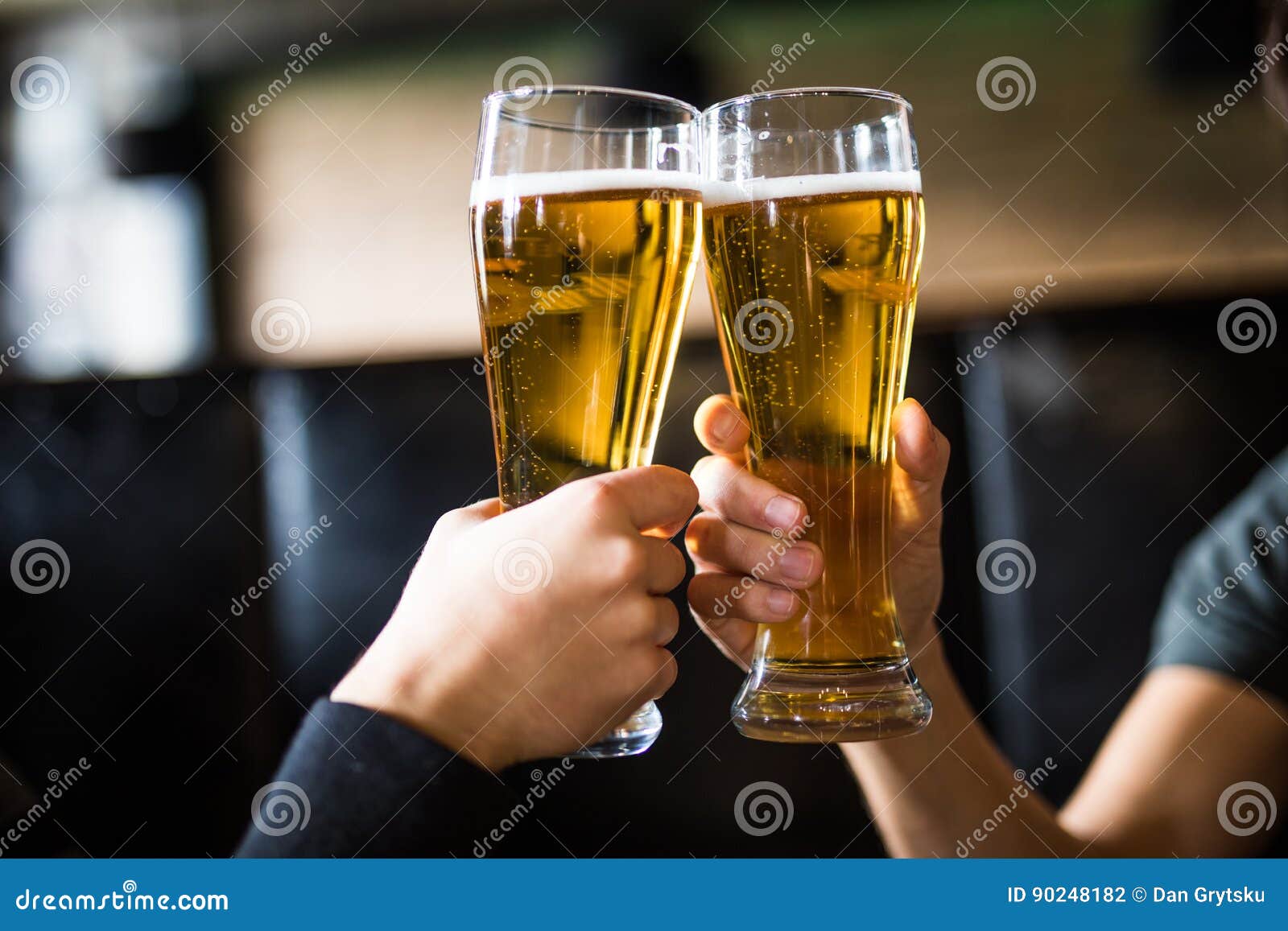 Men Cheers with Beer in Glasses in Pub. Close Up. Stock Photo Image
