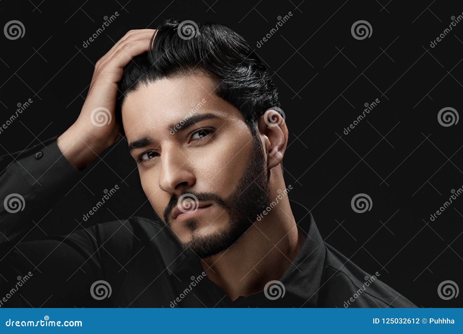 men hair care. man with beard, beauty face touching black hair