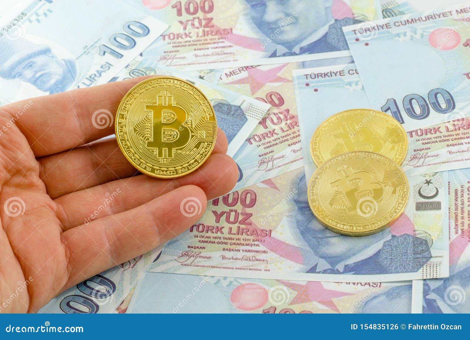 Men Hold Bitcoin Over Turkish Banknotes. Stock Photo ...