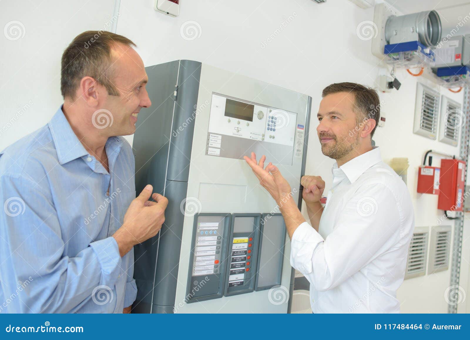 Men Looking at Electrical Equipment Stock Photo Image of show