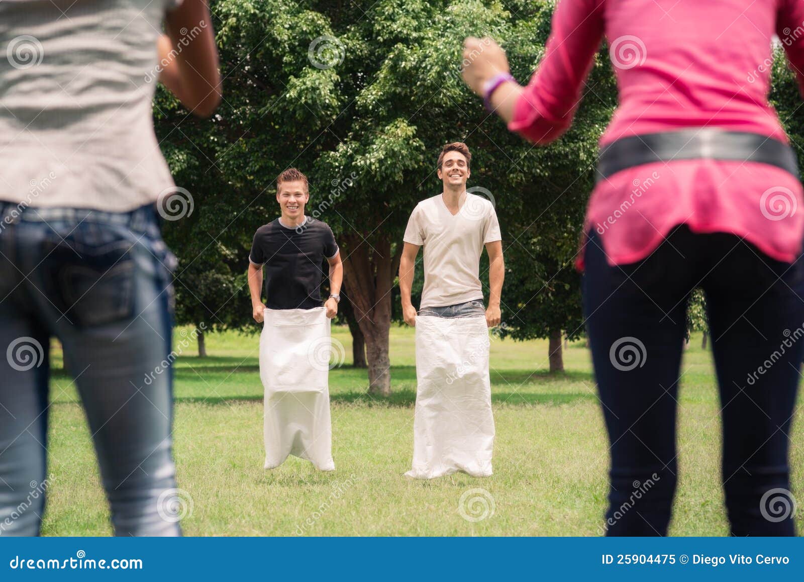 Men Playing Sack Race with Girlfriends Cheering Stock Image - Image of ...