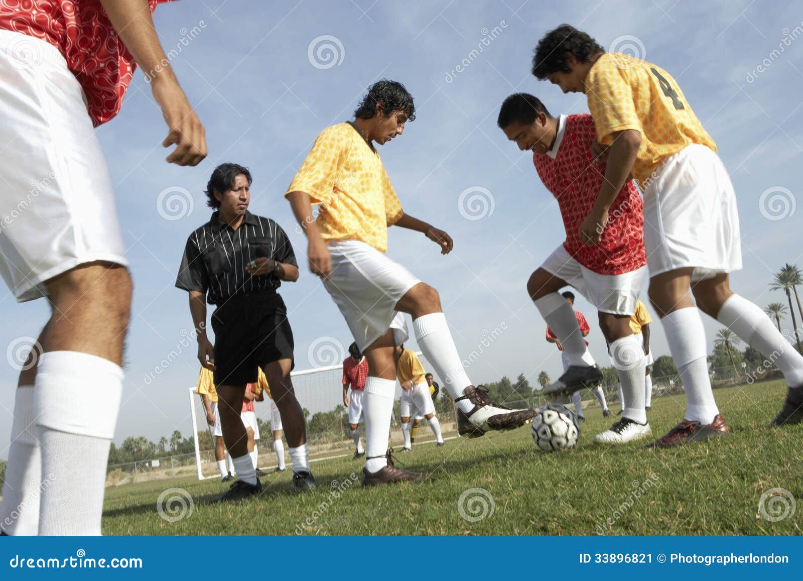 Men Playing Soccer while Referee Watching Them Stock Image Image of