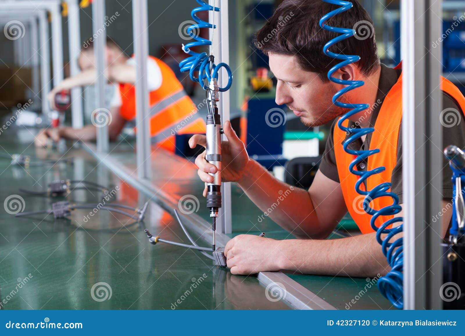 men during precision work on production line