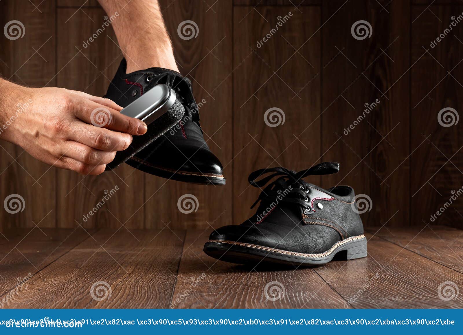 Men`s Hands Clean Black Shoes on a Wooden Background. the Concept of ...