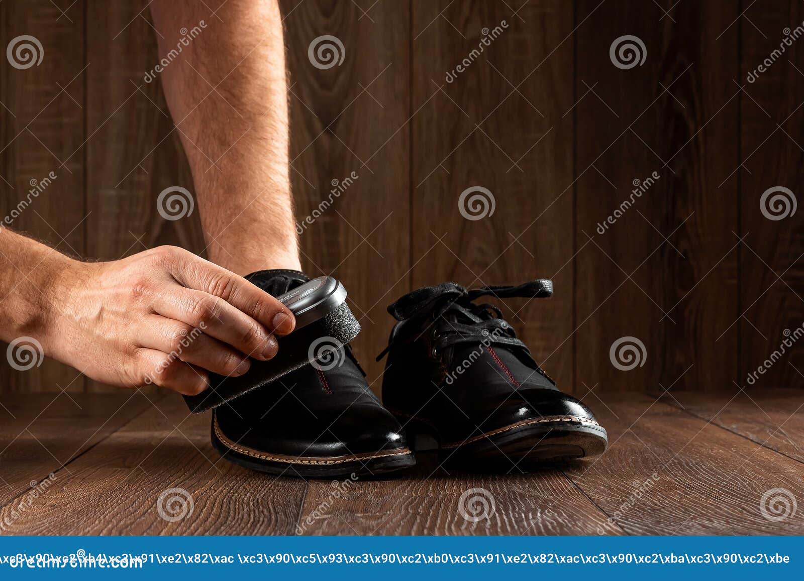 Men`s Hands Clean Black Shoes on a Wooden Background. the Concept of ...