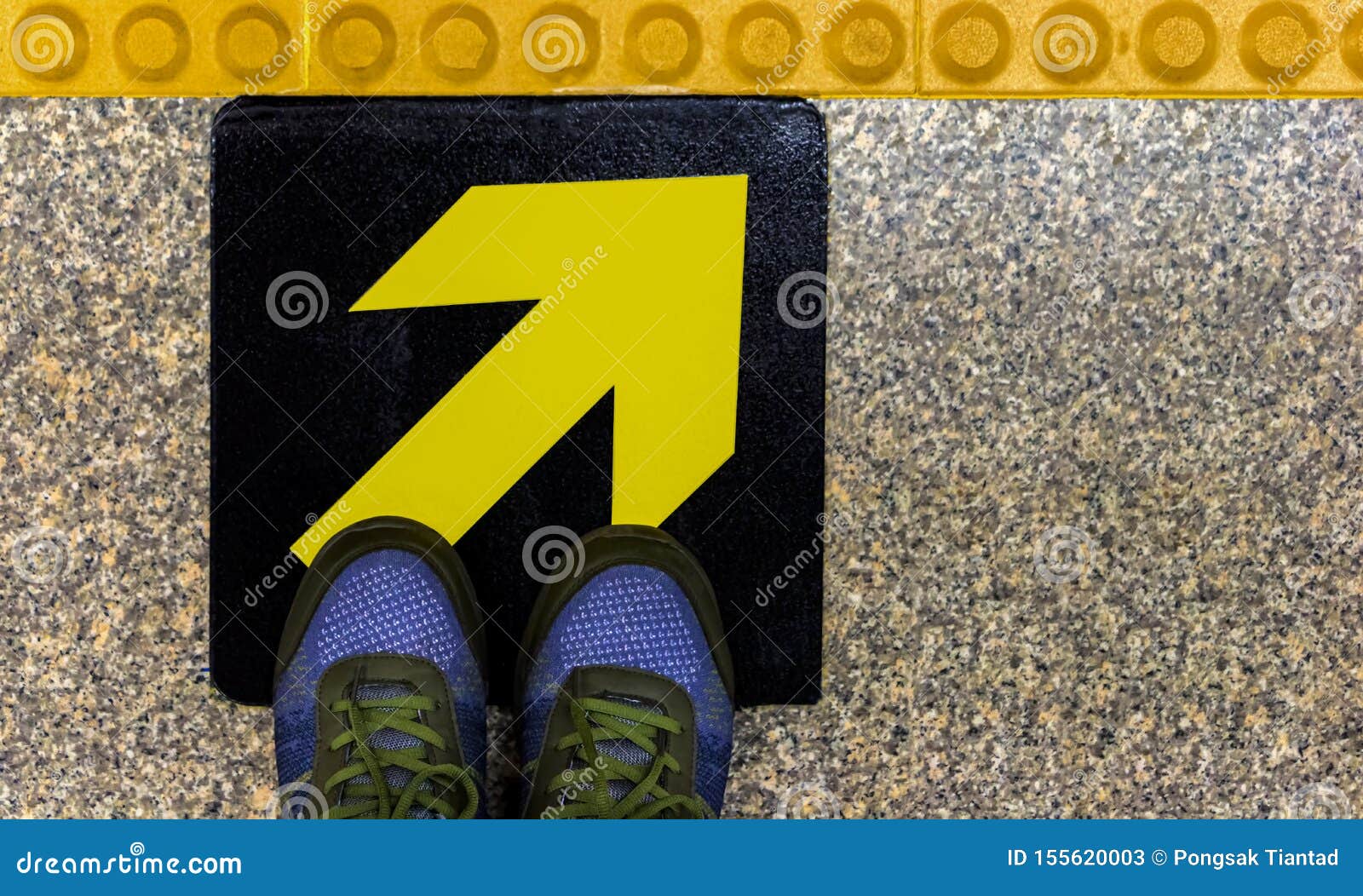 men`s shoes on a yellow guidepost on a concrete floor. the concept of a decision made in accordance with our guidelines