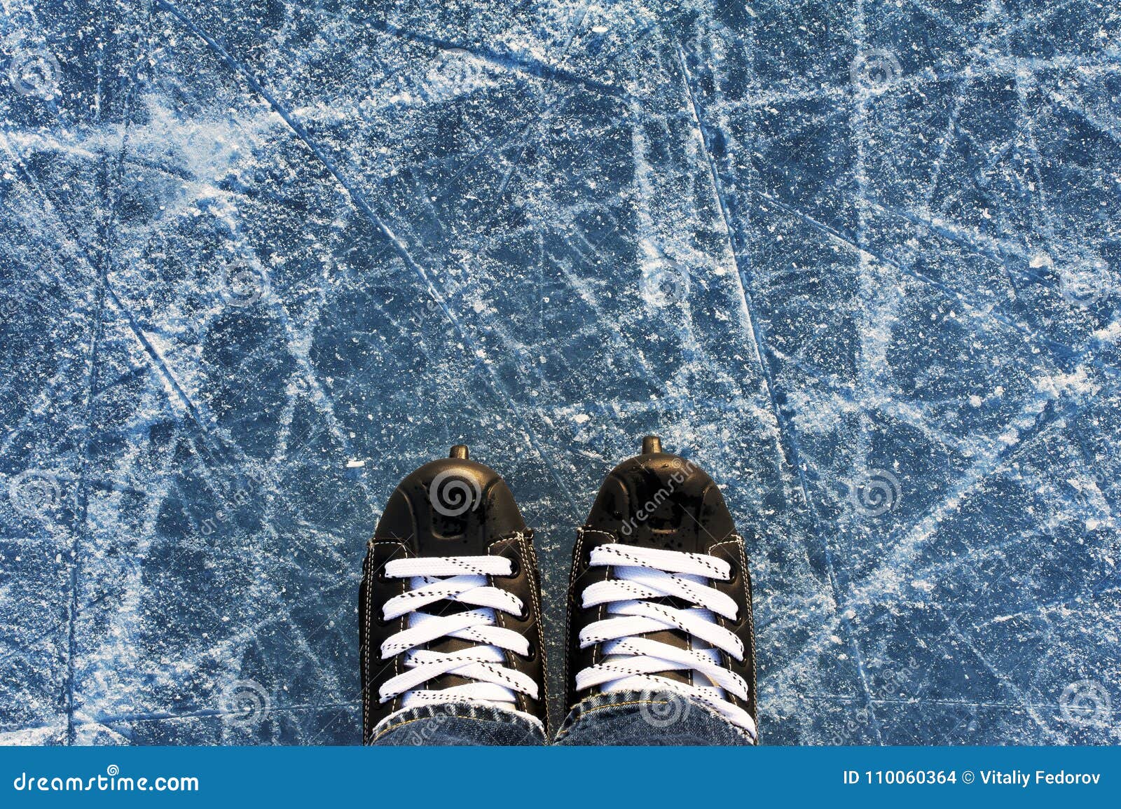 Men`s skates black on ice stock photo. Image of light 110060364