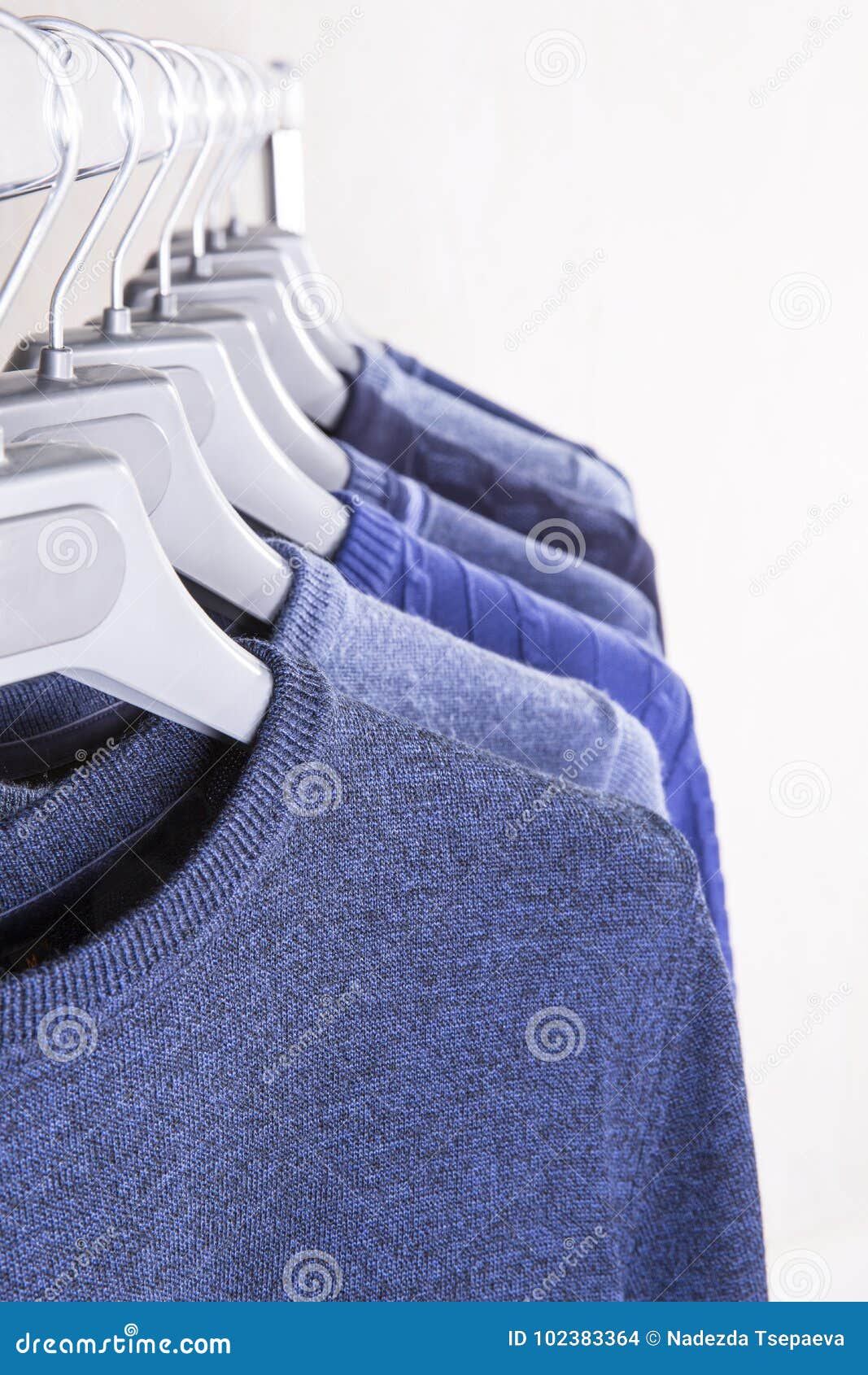 Men`s sweaters on hangers stock photo. Image of style - 102383364