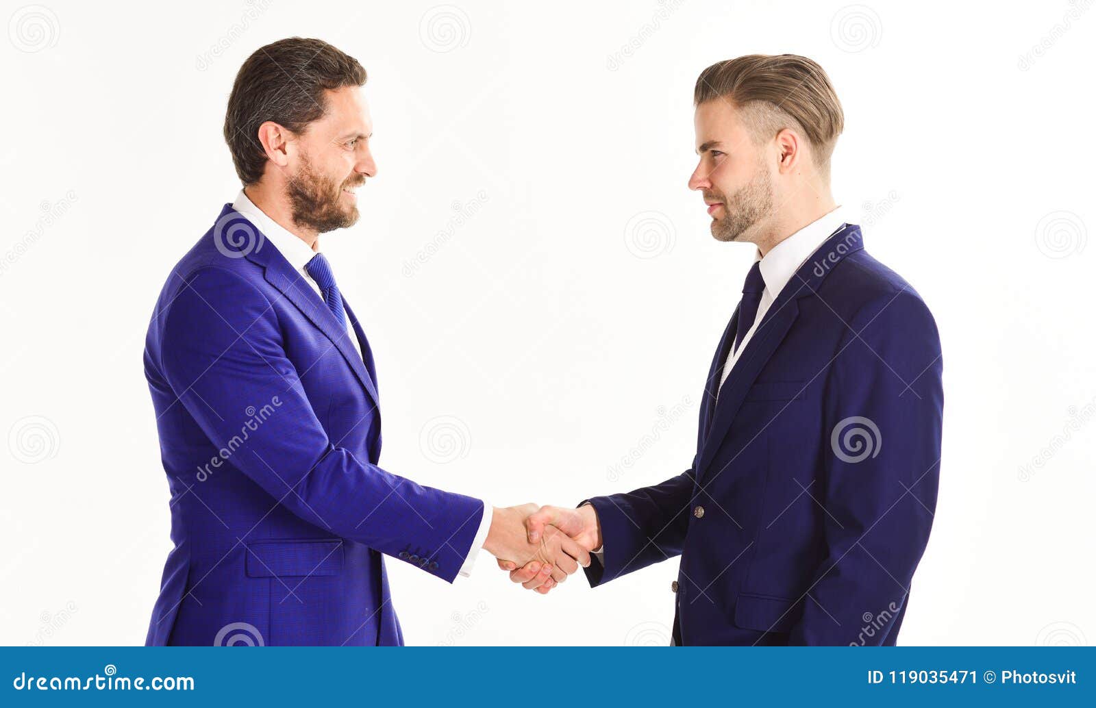 men in suits or businessmen hold hands in handshake.