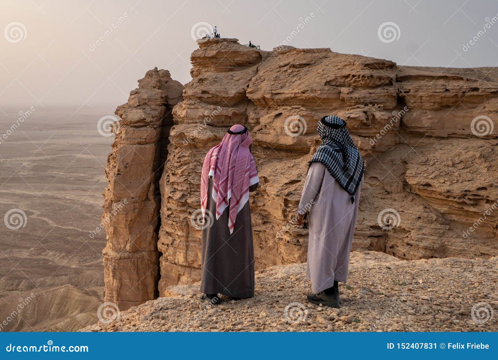 two arab men in traditional clothing at the edge of the world near riyadh in saudi arabia