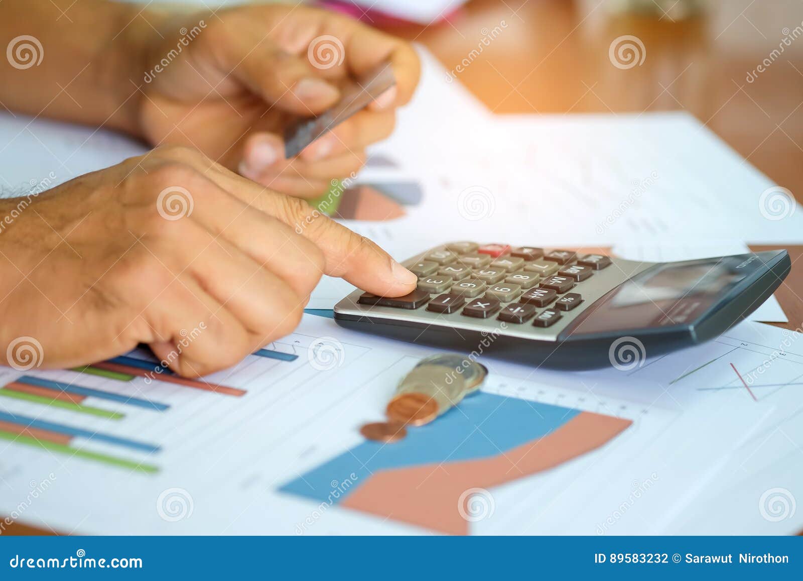 Men are Using Calculator To Analyze the Cost of a Credit Card. Stock