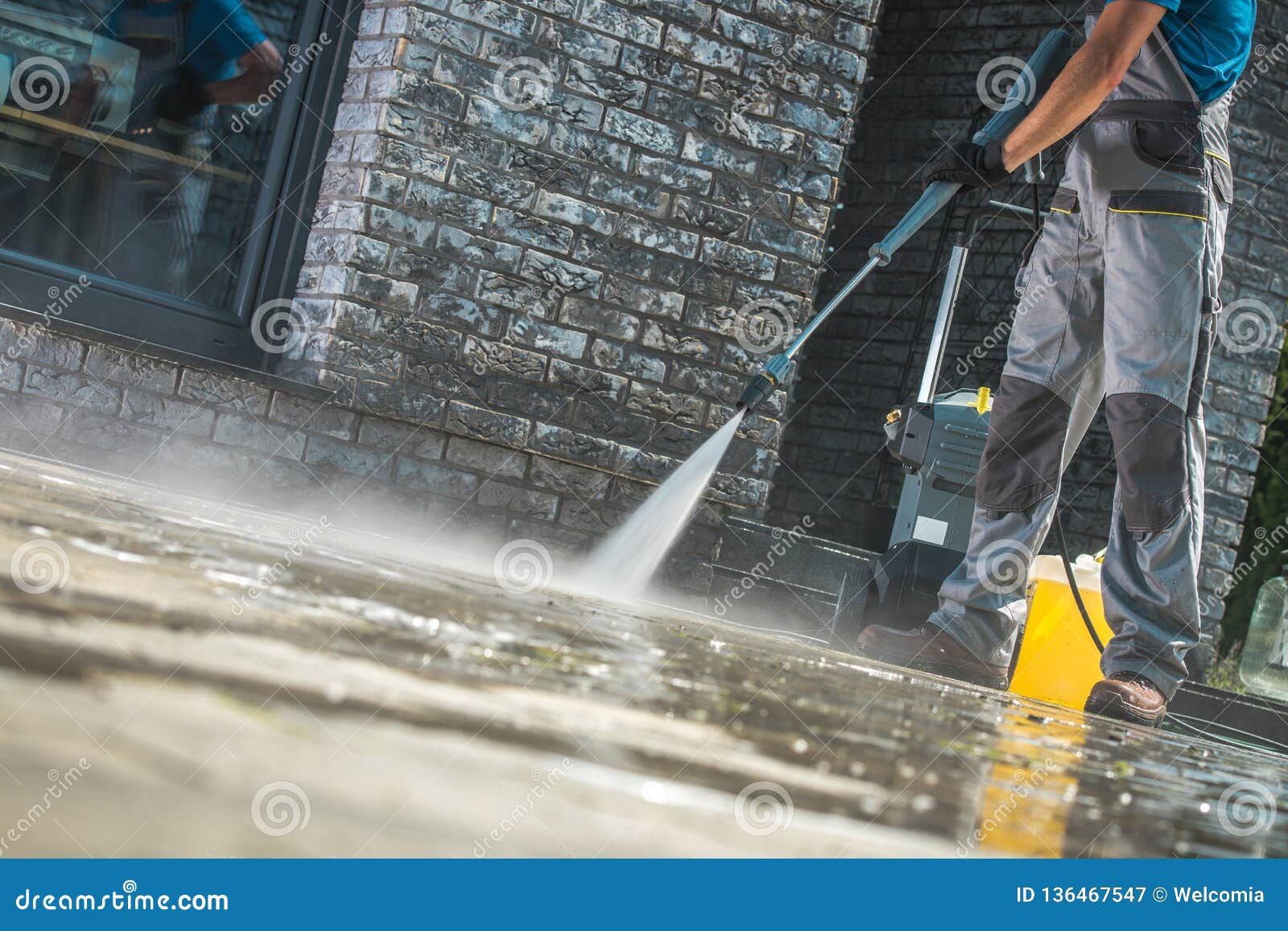 men washing driveway