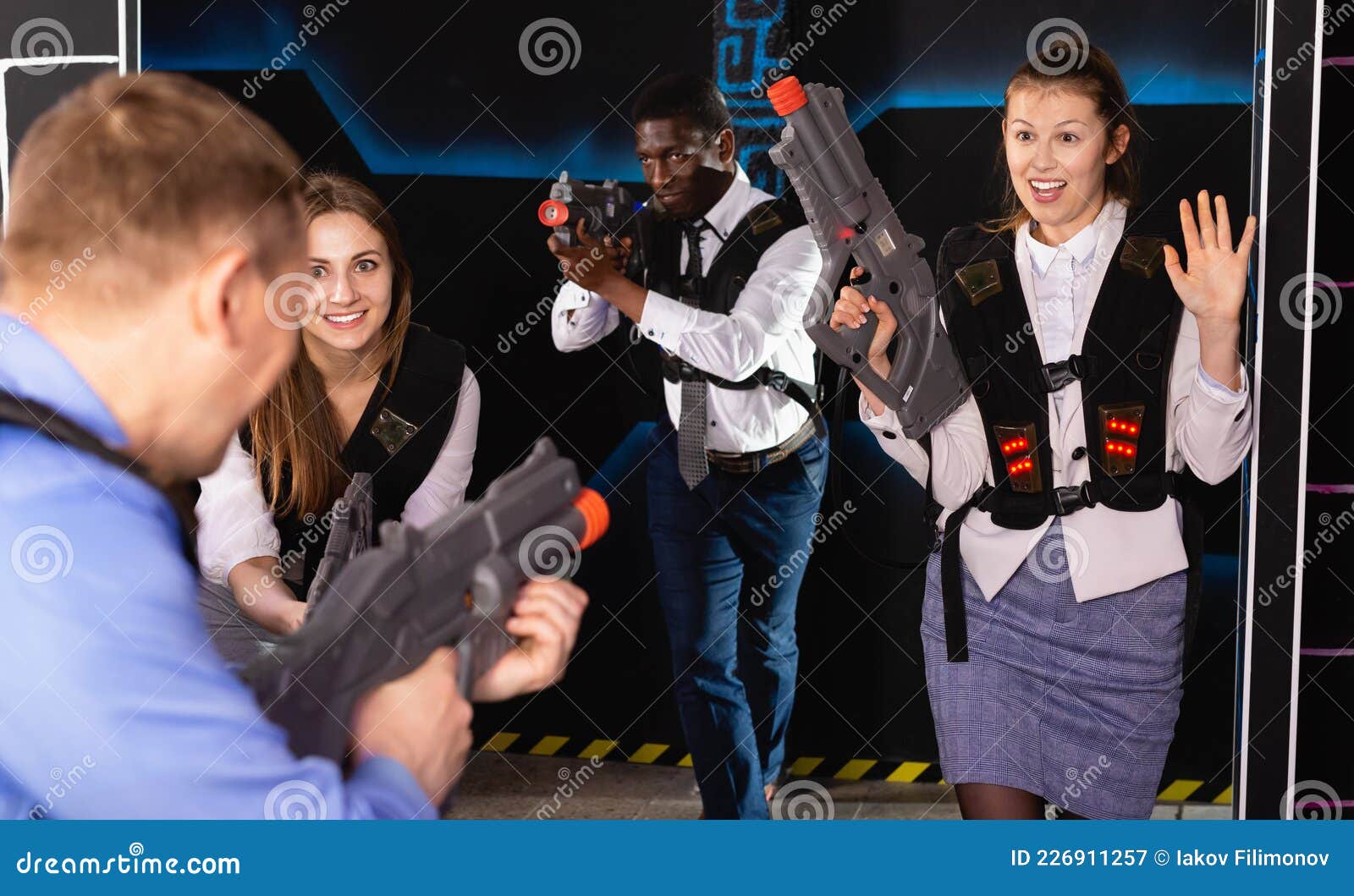Men And Women In Business Suits Playing Laser Tag Emotionally In Dark men-and-women-in-business-suits-playing-laser-tag-emotionally-in-dark